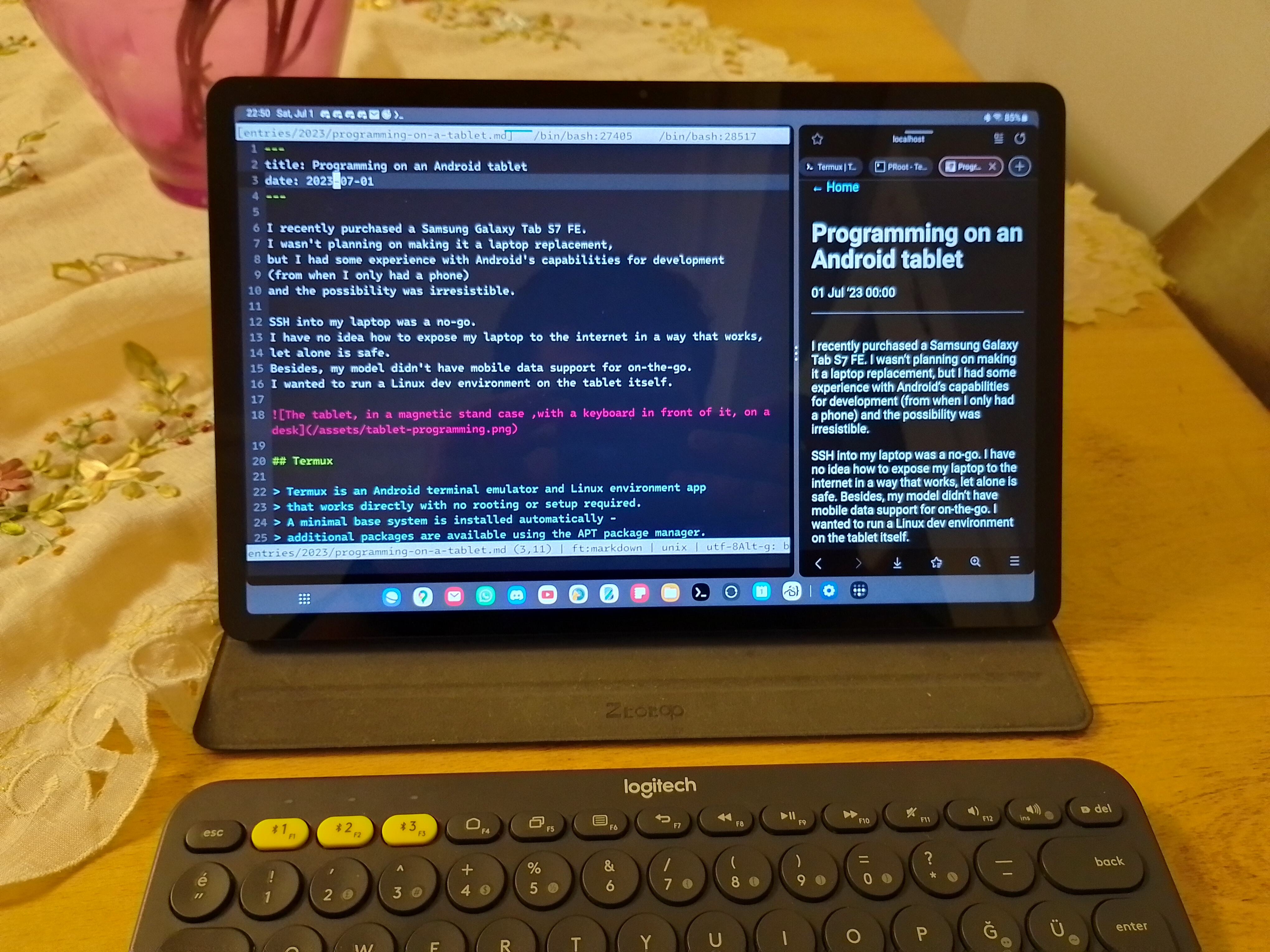 The tablet, in a magnetic stand case, with a keyboard in front of it, on a desk